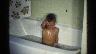1959: the small boy bath in our house near to wall,pipe towel hair