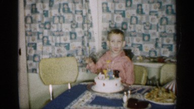 1959: young boy enjoying his birthday cake, all by himself. MICHIGAN