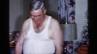 1955: grandparents playing with grand child with toy pony. NEW YORK