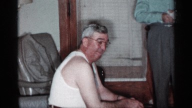 1955: a old man and young man talking and smiling the man eating