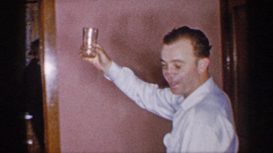 1955: a man walk the our house take in a yellow glass go to back in women