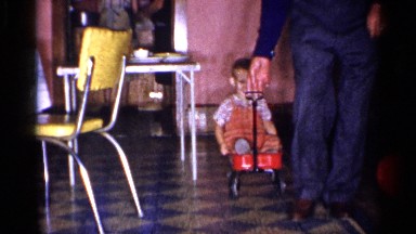 1955: man in blue gives the most fun ride in a red wagon NEW YORK