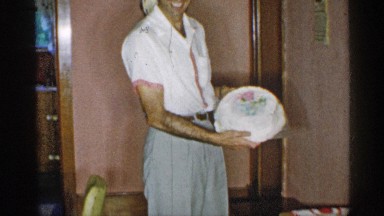 1955: a man preparing cake by himself and place the cake on the table