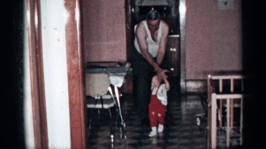 1955: a grandfather helping his grandchild to take his first steps NEW YORK