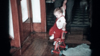 1955: a baby trying to walk with their walker on their home NEW YORK