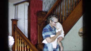 1955: an older lady holding a toddler is seen walking down the stairs NEW YORK