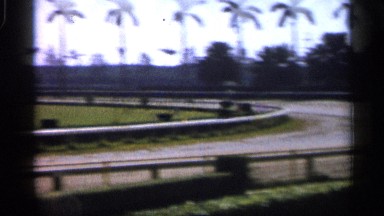 1958: Camera Coursing Tropical Racetrack and Stopping with a Close Up of a Man
