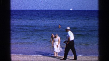 1958: grandparents and grandchildren at beach, grandchildren in the sea FLORIDA