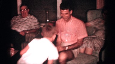 1958: father and son having a good time rough housing each other in the family