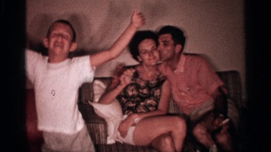 1958: young boy happily dancing in his living room while his parents watch