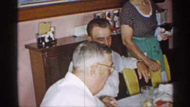 1955: men smoking at a dinner table NEW YORK