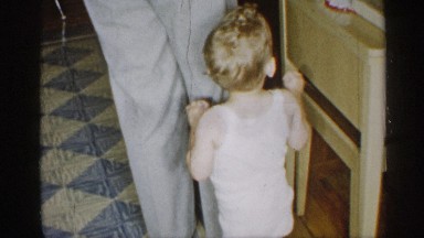 1955: a kid and her father at their home and the father made a cake to cut