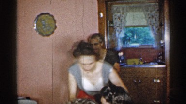 1955: one house men and women old women serve the birthday cake near to another