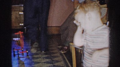 1955: a kid walking inside the house at the place of dining hall