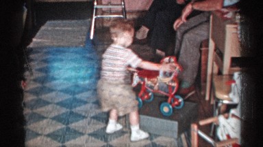 1955: the baby played with his toy in front of the peoples the baby is so cute