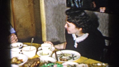 1955: happy family celebrating a son's warm birthday with food cooked by the mom