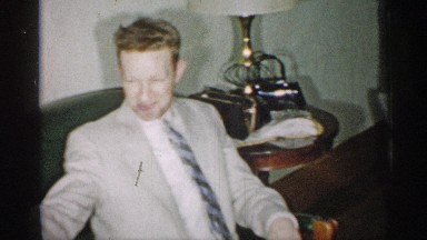 1955: old man and his family having some time together and having fun on dinner