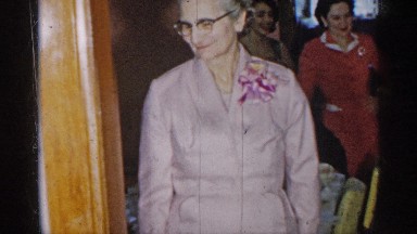 1955: a old women wait for the our guest anther person eat for the table lunch