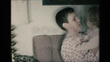 1959: a little girl sleep in our father solder father sit in the place furniture