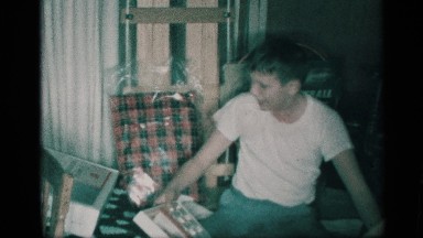 1959: a young boy whips his head about in front of a christmas tree NEW YORK