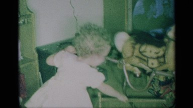 1959: childhood memory of a girl playing with her toys in her room and feeding