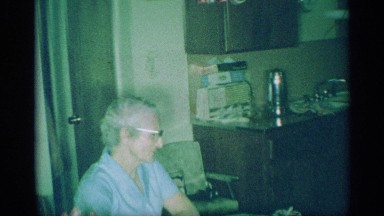 1959: a lady prepare the food at the kitchen and talking to the old man