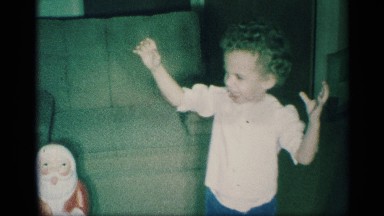 1959: a young child is walking around her living room on christmas morning