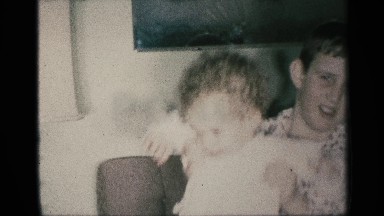 1959: A Child Playfully Bounced on a Boy's Knee in New York