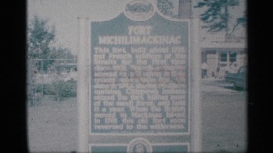 1959: the big sign board in white letter black back big wall near the road