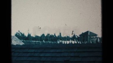 1959: a medium size street with some houses and building at the outside view