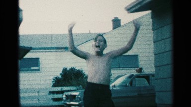 1959: young shirtless boy waving his hands and playing with his hair. NEW YORK