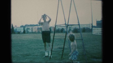 1959: two kids are outside enjoying each others company playing on equipment