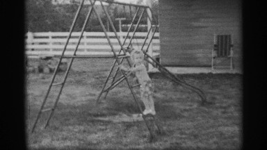 1959: young boy walking backwards down a play set stairs NEW YORK