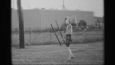 1959: the man walk the ground collect the dust in the back near the road