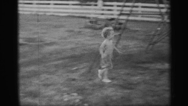 1959: exterior of enclosed play area with child running through it, plus outdoor