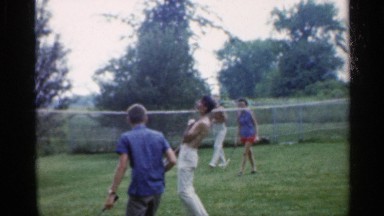 1959: four people are playing at the ground in this a lady and four guys