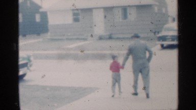 1959: the man and boy are walking near the car and the dog barks to see the man