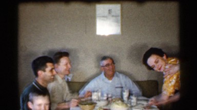 1959: many peoples peoples are sit at the dining table and serve food the boy