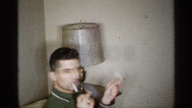 1959: two men and two women sit in living room when one man lights cigarette
