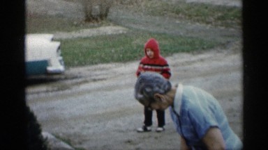 1959: older woman and child playing on a dirt road INDIANA