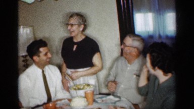 1959: party of friends gathered in table,enjoying eat with her mom INDIANA