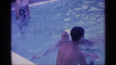 1959: a family happy in the swimming pool play in the both in the morning time