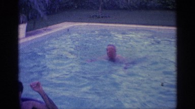 1959: people swim and play with floaters in a pool on a fun warm day. INDIANA