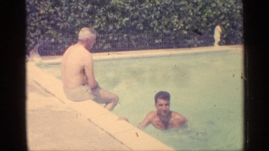 1959: a lady swims around in a pool, and other people enjoying the pool. INDIANA
