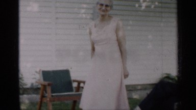 1959: a grand lady dancing little at the open place of their house