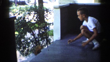 1959: a little boy play with squirrel and it get some food from him and run away