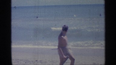 1959: the boys bare played in beach using the wooden piece and at the sea