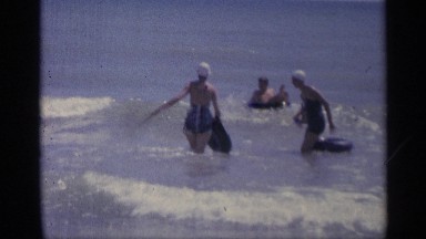 1959: people playing in the water with floating devices. INDIANA