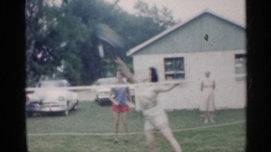 1959: girls playing badminton on a sunny day. INDIANA