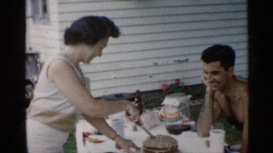 1959: woman outdoors at a table cutting a cake. INDIANA